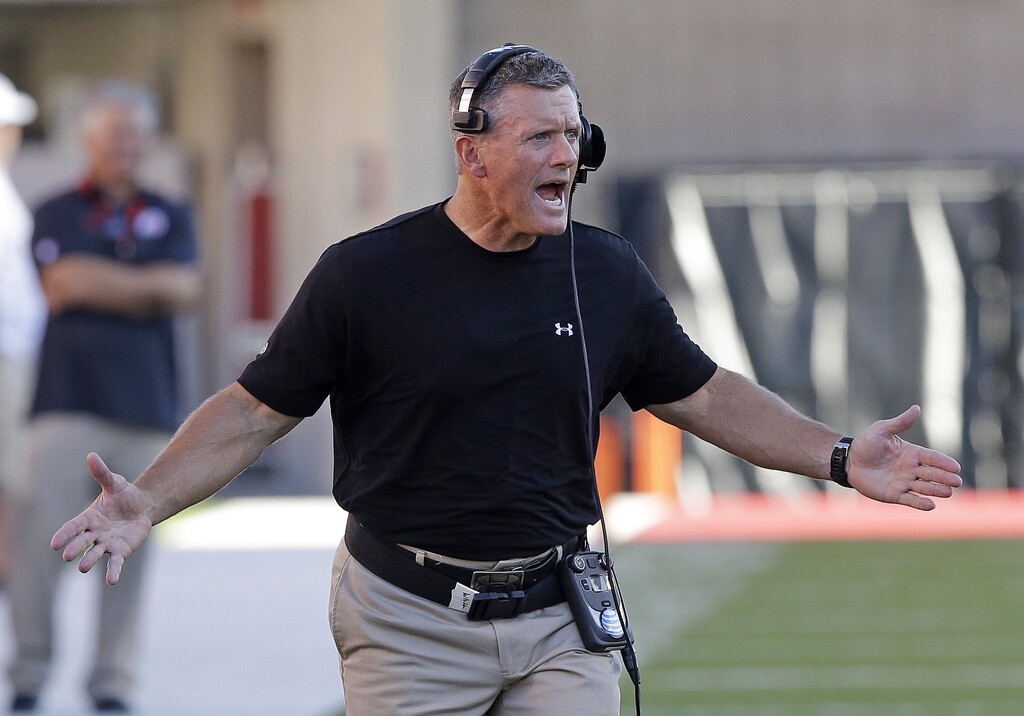FILE - In this Aug. 28, 2014, file photo, Utah head coach Kyle Whittingham shouts as he runs onto the field in the first quarter during an NCAA football game against Idaho State in Salt Lake City. Utah and Whittingham have agreed to the terms of a new four-year deal that could keep him with the program through 2018. (AP Photo/Rick Bowmer, File)
