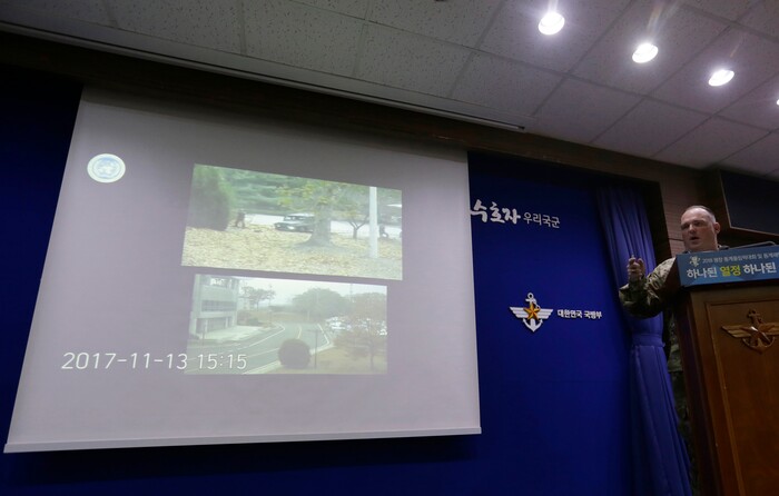 Col. Chad G. Carroll, a spokesman for the U.N. command, shows the CCTV footage regarding a North Korean soldier's defection during a press conference at the Defense Ministry in Seoul, South Korea, Wednesday, Nov. 22, 2017. A North Korean soldier made a desperate dash to freedom in a jeep and then on foot, being shot at least five times as he limped across the border and was rescued by South Korean soldiers, according to dramatic video released by the U.S.-led U.N. command Wednesday. (AP Photo/Ahn Young-joon)