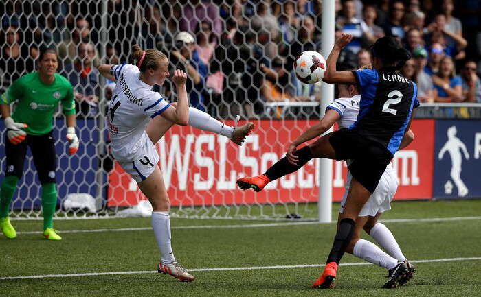 FC Kansas City's Becky Sauerbrunn (4) clears the ball from in front of the goal as Seattle Reign FC's Sydney Leroux threatens to score late in the second half of the NWSL championship soccer match Sunday, Aug. 31, 2014, in Tukwila, Wash. Kansas City won 2-1. (AP Photo/Elaine Thompson) 