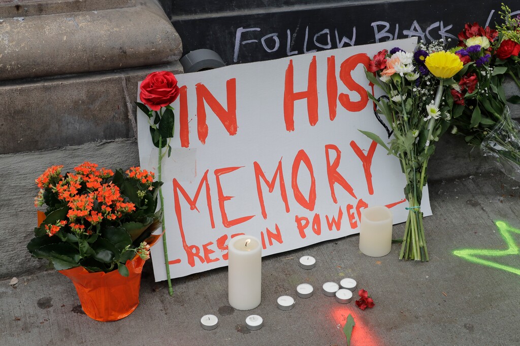 (Ted S. Warren | The Associated Press) A sign that reads "In his Memory Rest in Power," is displayed at a growing memorial to a person named Lorenzo, Saturday, June 20, 2020, at the intersection of 10th Ave. and Pine St. near the Capitol Hill Occupied Protest zone in Seattle. A pre-dawn shooting near the area left one person dead and critically injured another person, authorities said Saturday. The area has been occupied by protesters after Seattle Police pulled back from several blocks of the city's Capitol Hill neighborhood near the Police Department's East Precinct building.