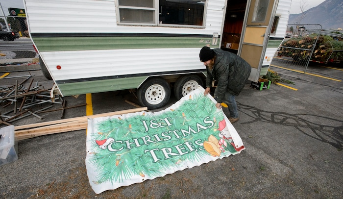 (Steve Griffin  |  The Salt Lake Tribune) Lucas  Brown sest up a J & T Christmas Tree lot at 7200 south 900 east in Middle, Utah Monday November 20, 2017. Utah Christmas tree lots will have less stock and higher prices this year due to a regional shortage of Christmas trees. 

I