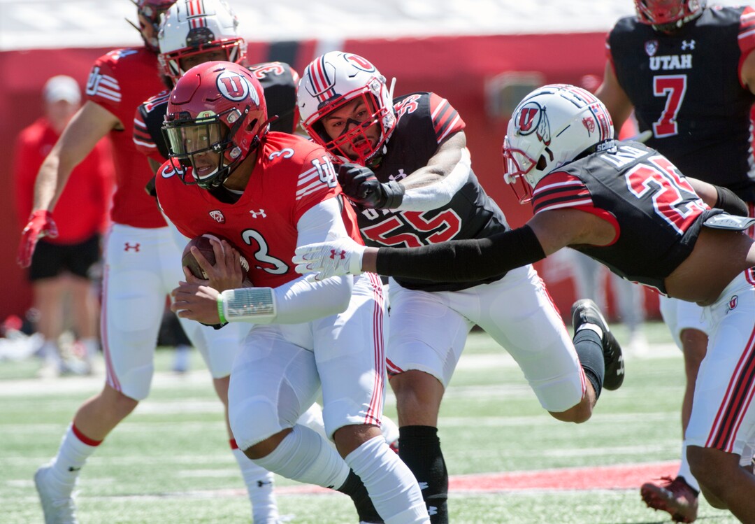 (Ed Kosmicki | Special to The Tribune) The red team running back Makai Cope #3 briefly eludes linebacker Andrew Mata'afa and teammate Jaylen Dixon #25 during the annual spring football game at the University of Utah, 17 April 2021.