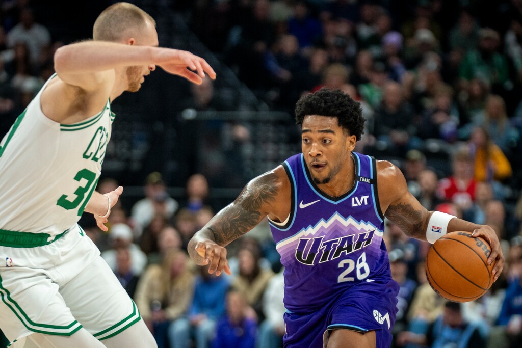 (Rick Egan | The Salt Lake Tribune) Utah Jazz forward Brice Sensabaugh (28) goes up the middle as Boston Celtics forward Sam Hauser (30) defends during a December game at the Delta Center.

