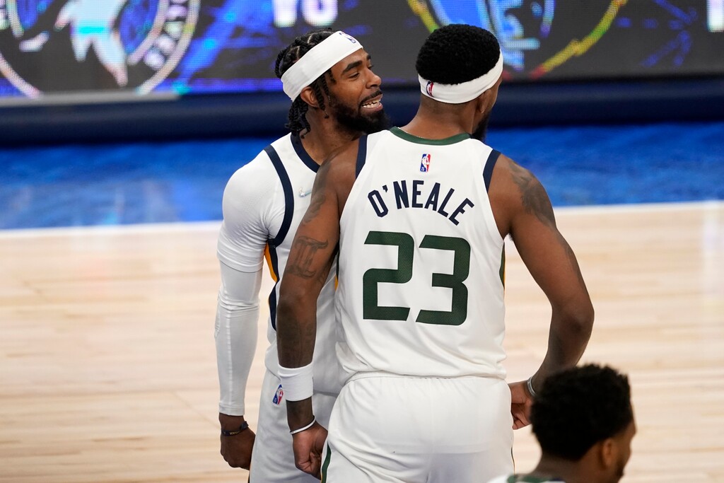 Utah Jazz guard Mike Conley, left, and Royce O'Neale (23) celebrate after a score by O'Neale in the second half of Game 1 of an NBA basketball first-round playoff series against the Dallas Mavericks, Saturday, April 16, 2022, in Dallas. (AP Photo/Tony Gutierrez)