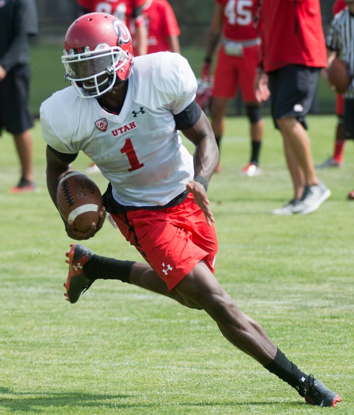 (Rick Egan  |  The Salt Lake Tribune)Utah quarterback Tyler Huntley runs the ball during practice, Monday, August 7, 2017.
