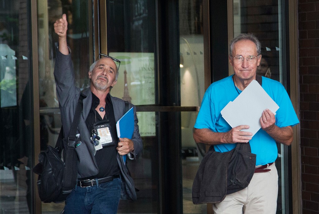 (AP Photo/Mark Lennihan)

New York Daily News staff photographers Todd Maisel, left, and Andrew Savulich walk out of the newspaper's office after being laid off, Monday, July 23, 2018, in New York. The tabloid will cut half of its newsroom staff, saying it wants to focus more on digital news.