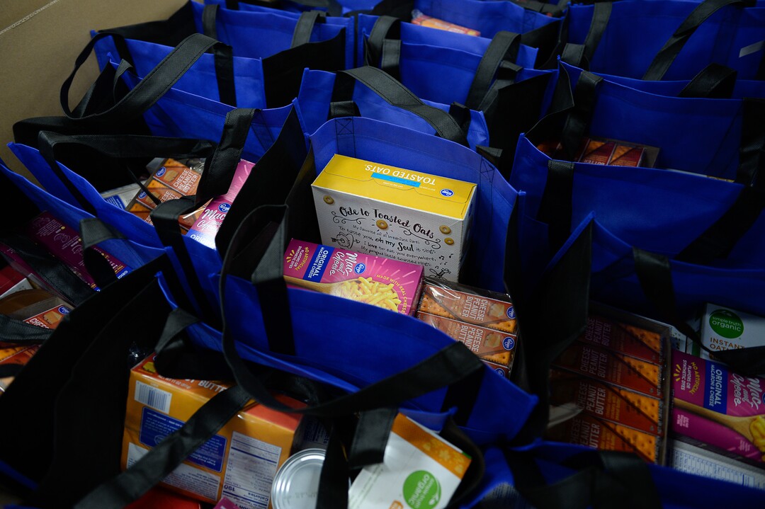 (Francisco Kjolseth  |  The Salt Lake Tribune)  Larger pantry bags of food await shipment as USANA staff volunteer their time assembling food bags for at-risk youth at the newly-renovated packing and storage facility next to the headquarters of the Salt Lake City company on Wed. Dec. 11, 2019. The USANA Foundation has acquired two local charities, Kids Next Door and KidsEat!, that provides hundreds of food bags every week for the kids for the weekends and during long school breaks.