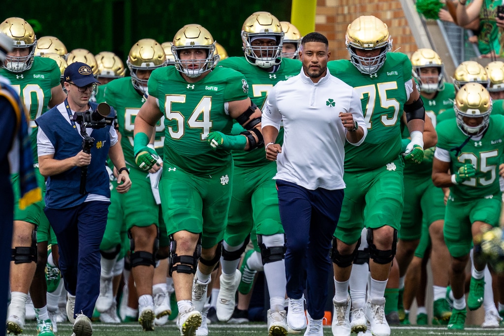(Paul Barnick | AP Photo) Notre Dame head coach Marcus Freeman leads his team onto the field before an NCAA college football game against Stanford, Saturday, Oct. 10, 2026, in South Bend, Ind.