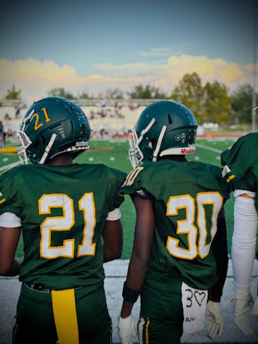 (Photo courtesy Abdifatah Osman): Kearns football players on the sideline of an undated game.