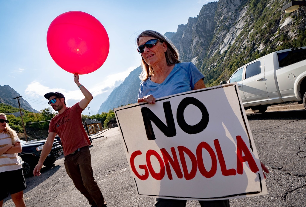 (Francisco Kjolseth | The Salt Lake Tribune) Environmental activists Jack Strauss and Jennifer Weiler fly large balloons over the mouth of Little Cottonwood Canyon on Saturday, Aug. 21, 2021, to demonstrate the height of the gondola towers the Utah Department of Transportation plans to build. Save Our Canyons, a nonprofit that works to protect the Wasatch Mountains, sued the Utah Department of Transportation on Monday, Dec. 11, 2023, citing the gondola plan.