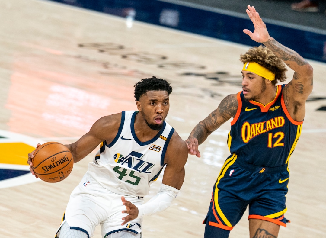 (Rick Egan | The Salt Lake Tribune) Utah Jazz guard Donovan Mitchell (45) takes the ball down court, as Golden State Warriors guard Kelly Oubre Jr. (12) defends, in NBA action between the Utah Jazz and the Golden State Warriors at Vivint Arena, on  Saturday, Jan. 23, 2021.