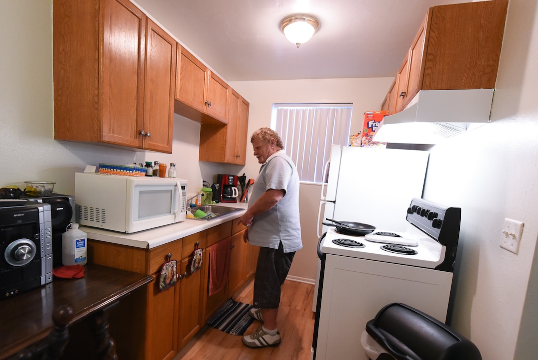 (Francisco Kjolseth  |  The Salt Lake Tribune)  Darwin Osborn, 64, is a Vietnam veteran who was homeless and searched for housing for over a year before landing a one-bedroom apartment in April 2019. He likes to keep a tidy place as he washes dishes in his kitchen. Osborn was housed with a VASH voucher and additional barrier removal support through additional funding provided by the state's "100 More Housed" initiative.