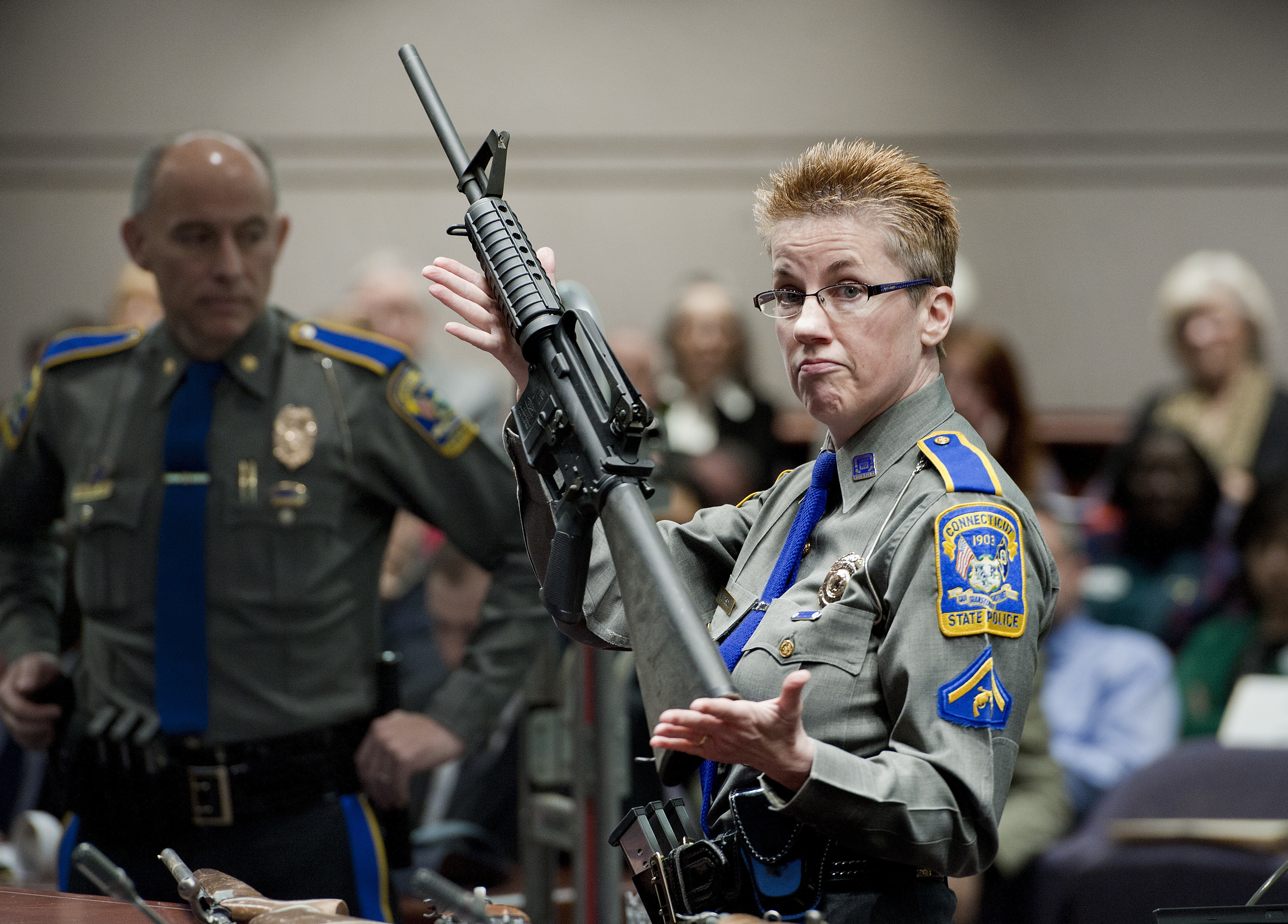 (Jessica Hill | AP file) Firearms training unit Detective Barbara J. Mattson, of the Connecticut State Police, holds a Bushmaster AR-15 rifle, the same make and model used by Adam Lanza in the 2012 Sandy Hook School shooting, during a hearing at the Legislative Office Building in Hartford, Conn., in January 2013.