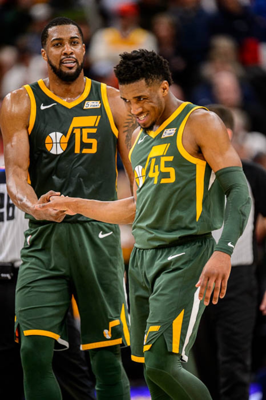 (Trent Nelson | The Salt Lake Tribune)  Utah Jazz forward Derrick Favors (15) and Utah Jazz guard Donovan Mitchell (45) celebrate the win as the Utah Jazz host the Milwaukee Bucks, NBA basketball in Salt Lake City on Saturday March 2, 2019.