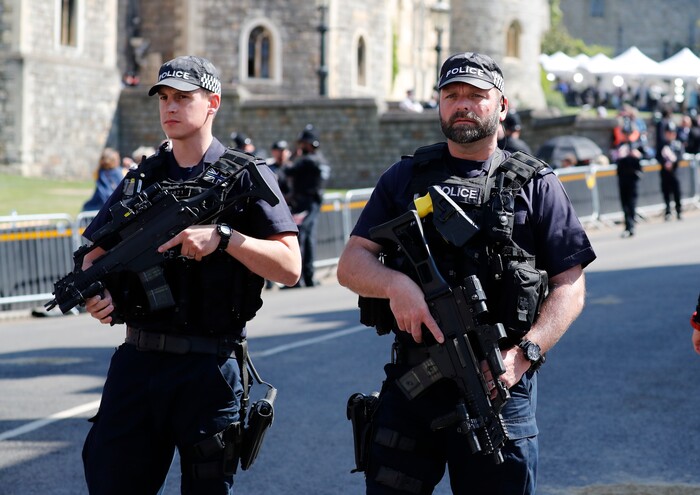 Armed police secure the route of the carriage procession prior to the wedding ceremony of Prince Harry and Meghan Markle at St. George's Chapel in Windsor Castle in Windsor, near London, England, Saturday, May 19, 2018. (AP Photo/Frank Augstein, pool)