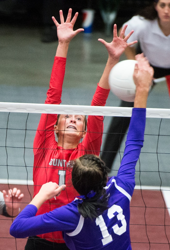 (Rick Egan  |  The Salt Lake Tribune)  Box Elder Bees Shayna Baugh (13) hits the ball as Bountiful Braves Baylee Mittelstaedt (1) defends, in 5A volleyball championship game, Bountiful vs. Box Elder, at Utah Valley University, Saturday, November 4, 2017.