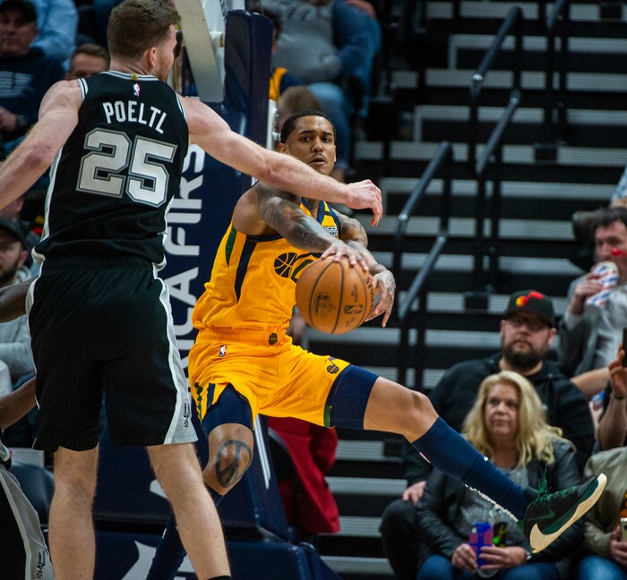 (Rick Egan  |  The Salt Lake Tribune)    
Utah Jazz guard Jordan Clarkson (00) tosses a pass around San Antonio Spurs center Jakob Poeltl (25), in NBA action between the Utah Jazz and the San Antonio Spurs, in Salt Lake City, Friday, Feb. 21, 2020.