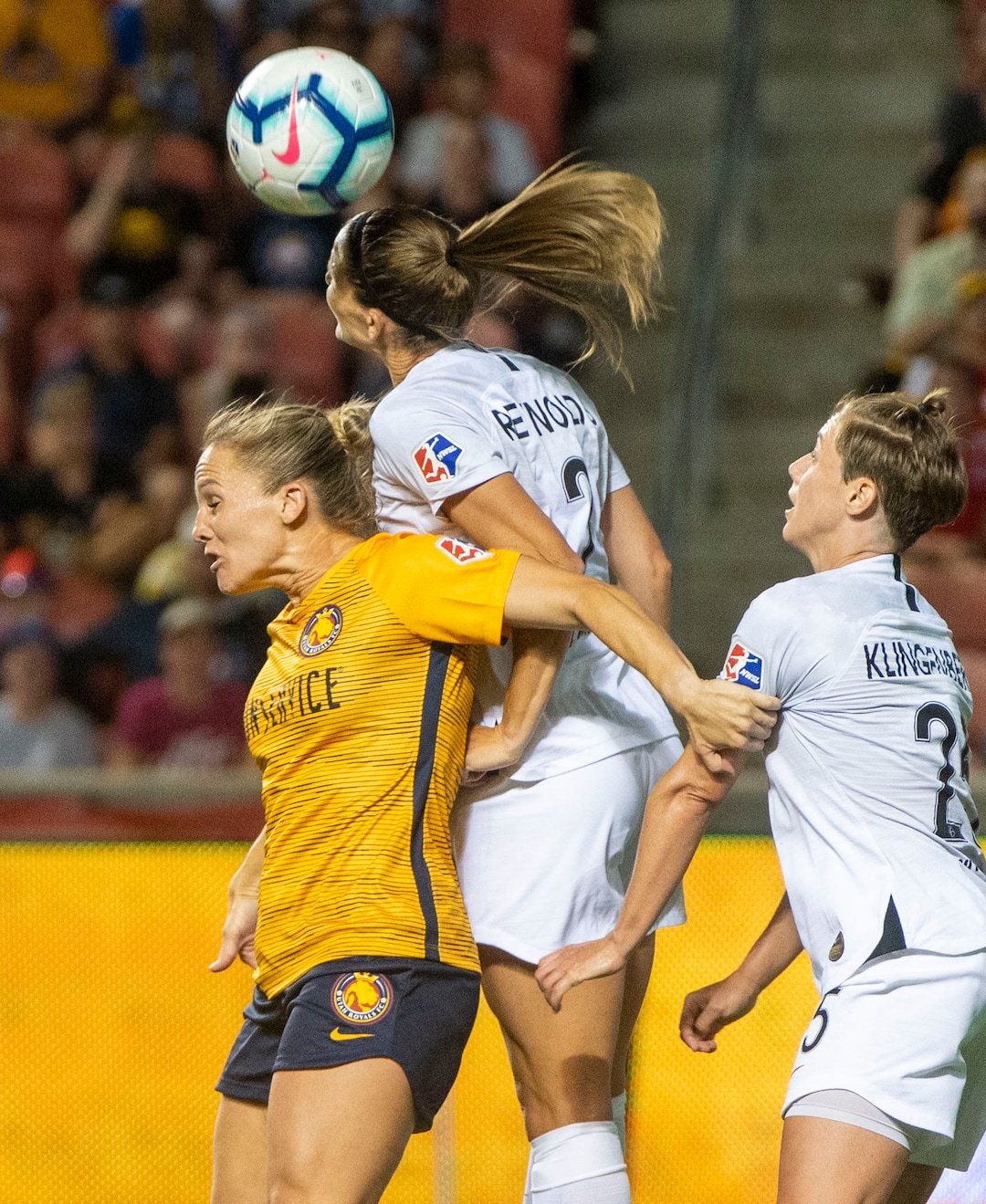 (Rick Egan  |  The Salt Lake Tribune)    Utah Royals FC forward Amy Rodriguez (8) goes for the ball as Portland Thorns FC defender Katherine Reynolds (2) and Portland Thorns FC defender Meghan Klingenberg (25), in Soccer action between Utah Royals FC and Portland Thorns FC, in Sandy, Friday, July 19, 2019.
