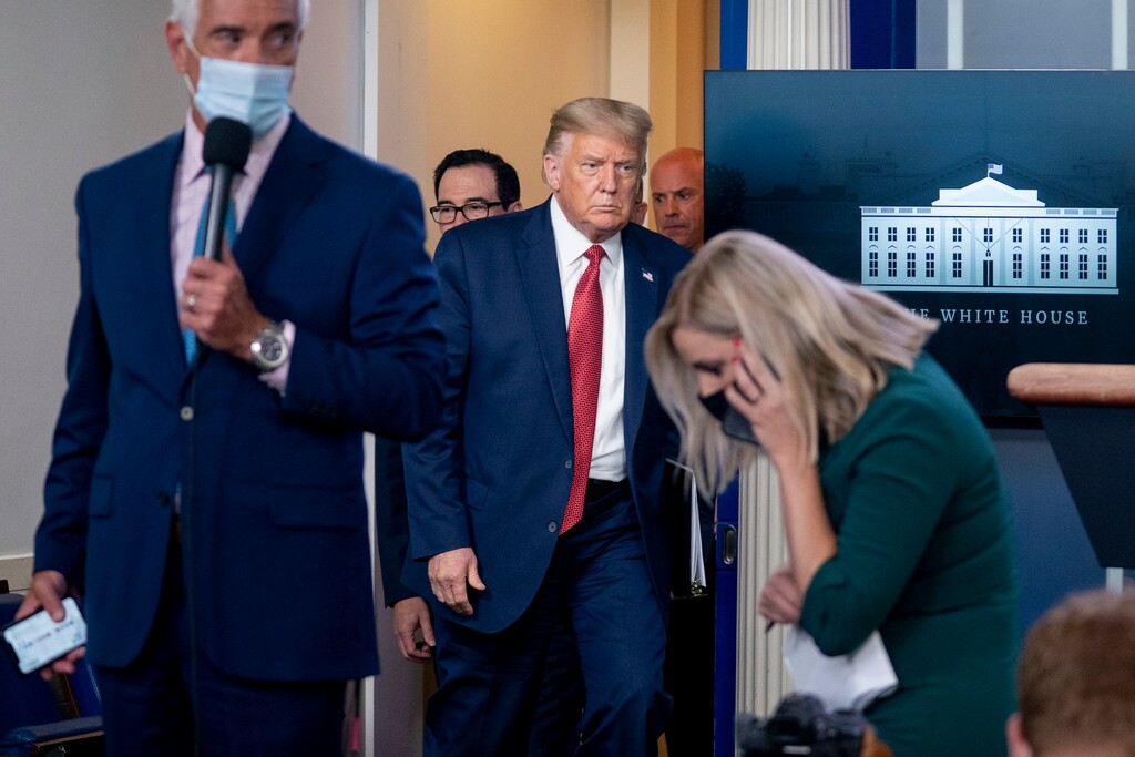 (Andrew Harnik | The Associated Press) President Donald Trump returns to a news conference in the James Brady Press Briefing Room after he briefly left because of a security incident outside the fence of the White House, Monday, Aug. 10, 2020, in Washington.