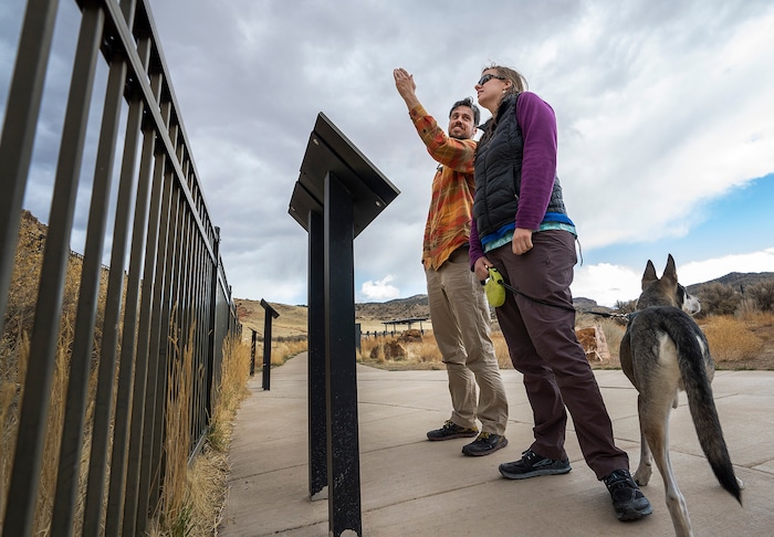 (Leah Hogsten | The Salt Lake Tribune) Garrett Colibri and Hayley Bahr discuss the Parowan Gap petroglyphs, Mar. 20, 2021 with Bahr's dog Niko.