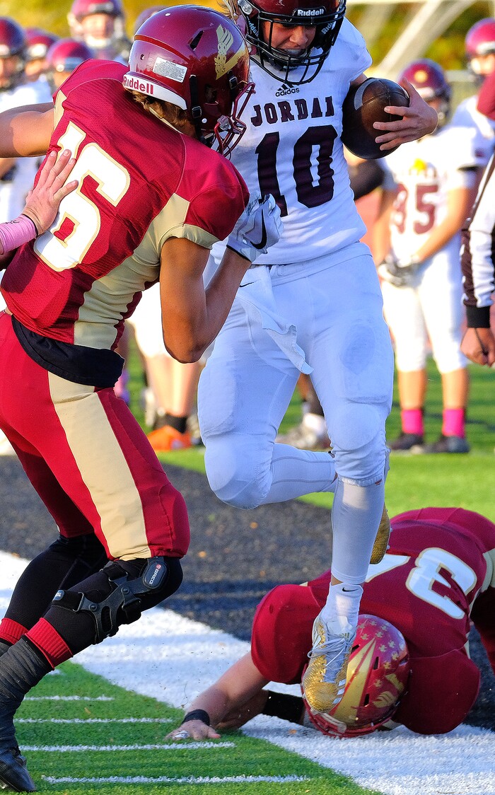 (Leah Hogsten  |  The Salt Lake Tribune) Jordan's  quarterback Crew Wakeley's is shoved out of bounds by Viewmont's Cole Salmon. Jordan High School boys' football team defeated Viewmont High School 28-20 during their class 5A football playoff opener, Friday, October 27, 2017 in Bountiful.