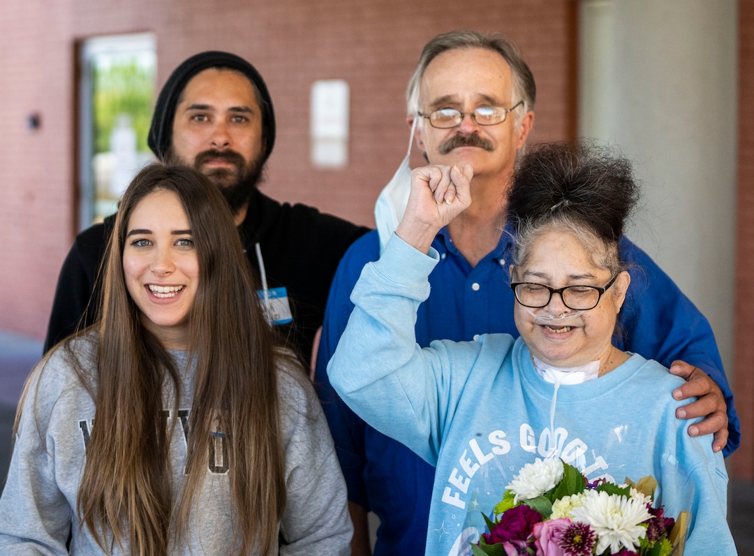 (Rick Egan | The Salt Lake Tribune) Tina Lewis poses for a photo with her son, Joseph, husband, Jeff, and daughter, Madii, as she leaves South Davis Community Hospital in Bountiful, Wednesday, Sept. 22, 2021. Lewis heads home to Idaho Falls, Idaho, after spending most of the past 6 months in hospitals sick with COVID-19.
