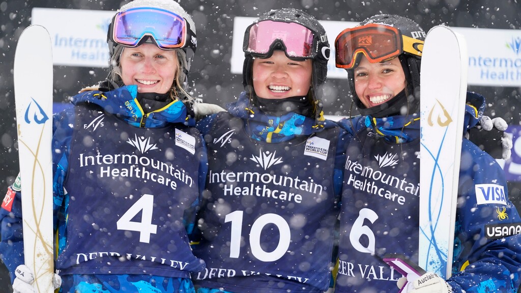 Kai Owens, center, celebrates after finishing first in the finals between Hannah Soar, left, who finished second, and Tess Johnson, who placed third, in the World Cup women's dual moguls skiing competition Friday, Feb. 5, 2021, in Deer Valley, Utah. (AP Photo/Rick Bowmer)