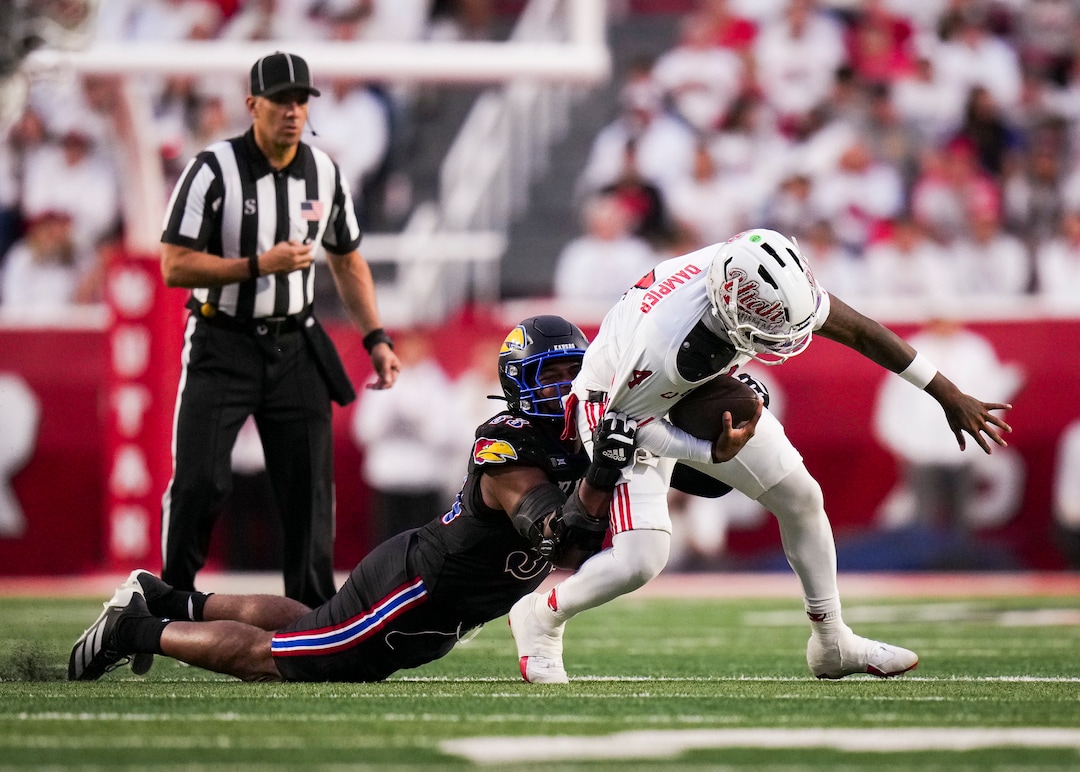 (Bethany Baker  |  The Salt Lake Tribune) Kansas Jayhawks defensive end Leroy Harris III (33) sacks Utah Utes quarterback Devon Dampier (4) during the game between the Utah Utes and the Kansas Jayhawks at Rice-Eccles Stadium in Salt Lake City on Saturday, Oct. 10, 2026.
