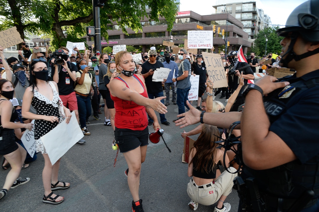 (Francisco Kjolseth  |  The Salt Lake Tribune) Victoria Crosby with Black Lives Matter receives a hand shake from officer M. Acosta as demonstrators protest against police brutality on Tuesday, June 2, 2020, in downtown Salt Lake City, as an 8 p.m. weeklong curfew remains in order.