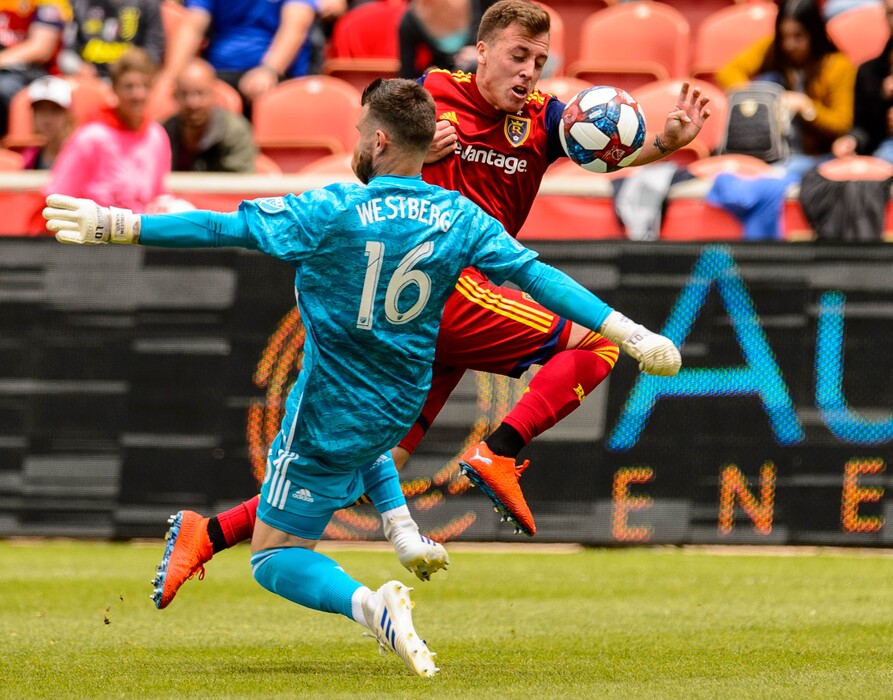 (Trent Nelson  |  The Salt Lake Tribune)  Real Salt Lake forward Corey Baird (17) pushes the ball past Toronto FC goalkeeper Quentin Westberg (16) as Real Salt Lake hosts Toronto FC, MLS Soccer at Rio Tinto Stadium in Sandy on Saturday May 18, 2019.