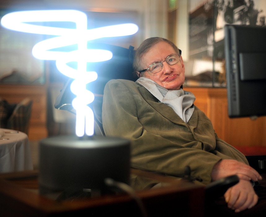 In this Feb. 25, 2012, photo, Professor Stephen Hawking poses beside a lamp titled "black hole light" by inventor Mark Champkins, presented to him during his visit to the Science Museum in London. Hawking, whose brilliant mind ranged across time and space though his body was paralyzed by disease, died early Wednesday, March 18, 2018, a University of Cambridge spokesman said. He was 76.
 (Anthony Devlin/PA via AP)