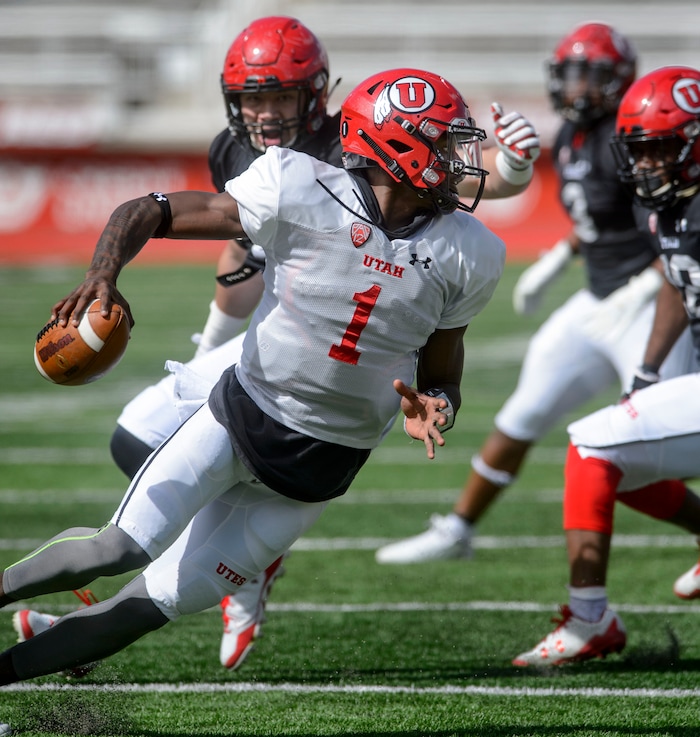 (Steve Griffin  |  The Salt Lake Tribune) Utah quarterback Tyler Huntley scrambles out of trouble during the University of Utah football team's first scrimmage at Rice-Eccles Stadium in Salt Lake City Friday March 30, 2018.