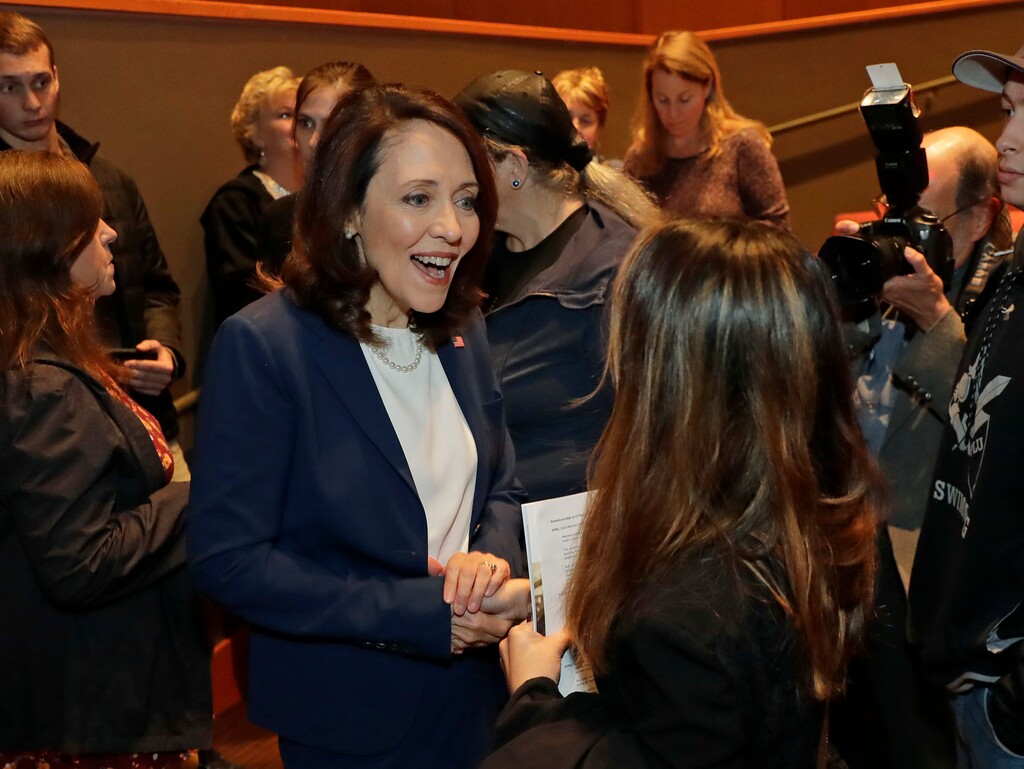 (AP Photo/Ted S. Warren) Sen. Maria Cantwell, D-Wash., left, talks with an audience member following a debate with Cantwell's Republican challenger, Susan Hutchison, Monday, Oct. 8, 2018, at Pacific Lutheran University in Tacoma, Wash.