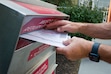 (Bethany Baker | The Salt Lake Tribune) A voter drops off two ballots at a ballot drop box at the Davis Conference Center in Layton on Monday, June 22, 2026.