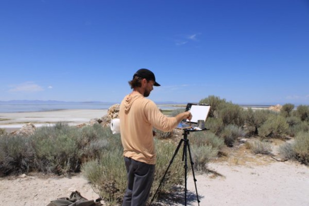 (Georgia Metcalf  |  Daily Utah Chronicle) Artist Erik Linton paints near the Great Salt Lake on July 20, 2026. Linton has set a goal of painting the lake every day for a year.