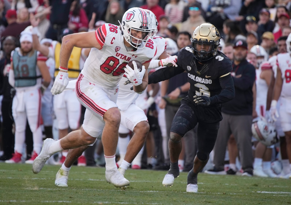 Utah tight end Dalton Kincaid, left, runs after catching a pass as Colorado safety Jeremy Mack Jr. (3) pursues in the first half of an NCAA college football game Saturday, Nov. 26, 2022, in Boulder, Colo. (AP Photo/David Zalubowski)