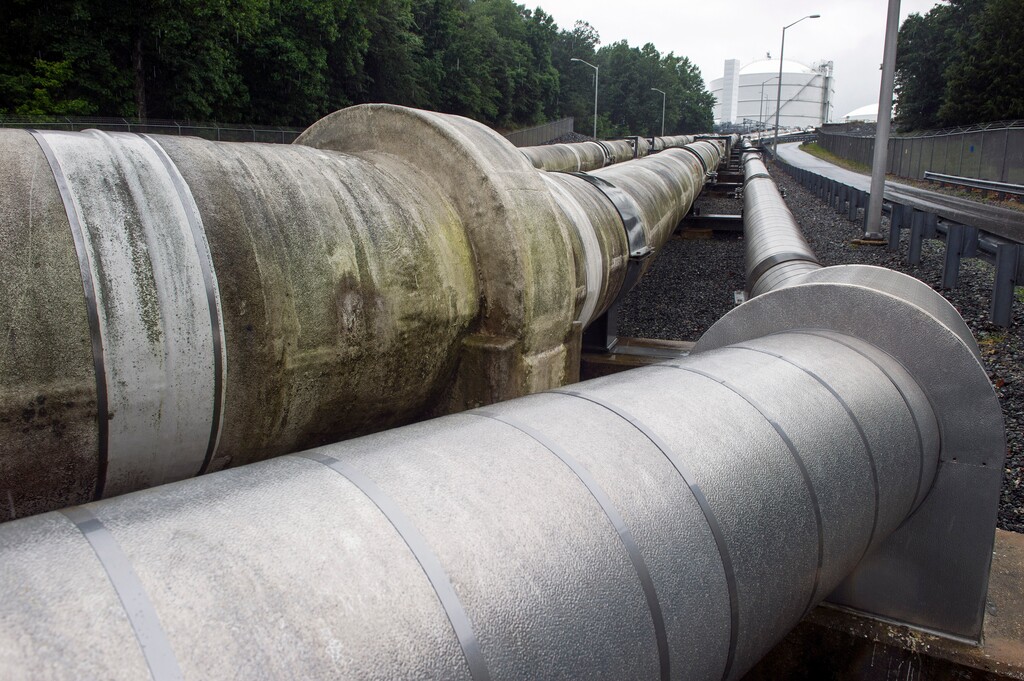 (AP file photo, June 12, 2014) Dominion Energy pipes carrying liquified natural gas to and from a holding tank, seen in background, at Cove Point LNG Terminal in Lusby, Md. The utility wants to build pipelines to rural Utah customers and is backing a fee on all residential customers bills statewide of $3 to $7 yearly to pay for the construction. A bill allowing those fees, HB422, sponsored by Rep. Mike Noel, R-Kanab, drew unanimous support in committee and now heads to the Utah House of Representatives.