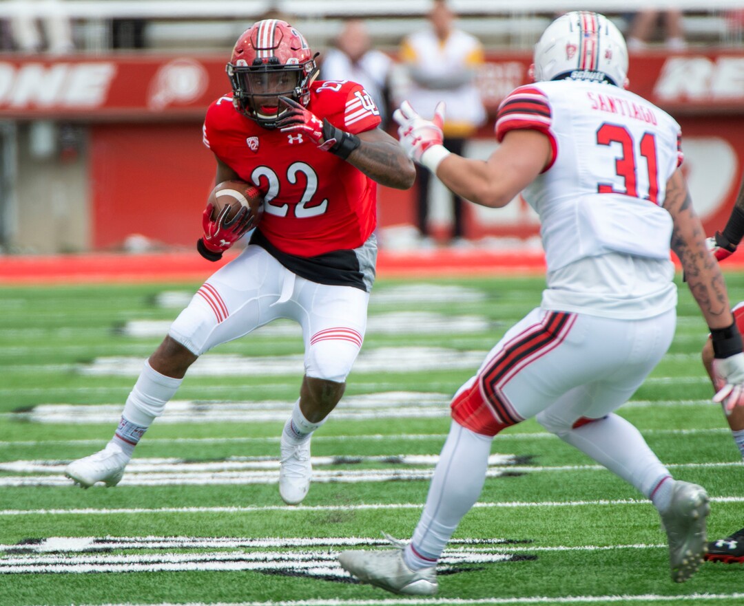 (Rick Egan  |  The Salt Lake Tribune)  Running back Devin Brumfield runs the ball as Keala Santiago defends on the play, in Utah's annual Read and White game at Rice-Eccles Stadium,Saturday, April 13, 2019.