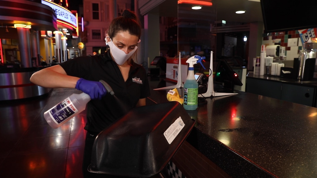 (Photo courtesy of Megaplex Theatres) An employee at the Megaplex Jordan Commons theater in Sandy sanitizes a booster seat. The Utah-based theater chain has announced it will reopen 12 Utah locations on Thursday, June 18, 2020, three months after theaters were closed due to the coronavirus pandemic.