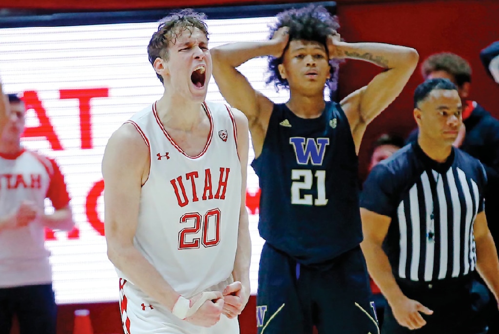 (Rick Bowmer | AP) Utah forward Mikael Jantunen (20) celebrates as Washington forward RaeQuan Battle (21) looks on at the end of their NCAA college basketball game Thursday, Jan. 23, 2020, in Salt Lake City. Utah won 67-66.