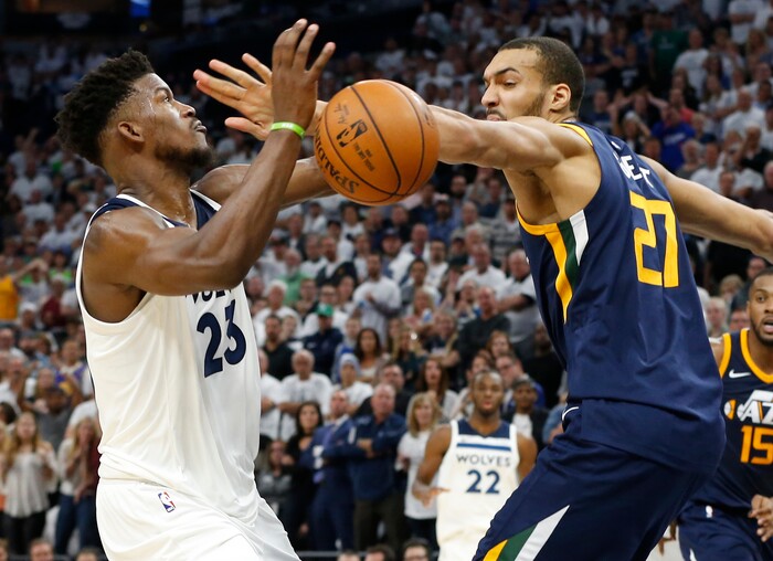 Utah Jazz's Rudy Gobert, right, knocks the ball away from Minnesota Timberwolves' Jimmy Butler during the fourth quarter of an NBA basketball game Friday, Oct. 20, 2017, in Minneapolis. The Timberwolves won 100-97. (AP Photo/Jim Mone)