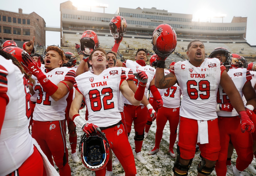 From left, Utah defensive back Keala Santiago, wide receiver Dylan Slavens and offensive lineman Lo Falemaka sing the school song with fans after an NCAA college football game against Colorado, Saturday, Nov. 17, 2018, in Boulder, Colo. Utah won 30-7. (AP Photo/David Zalubowski)