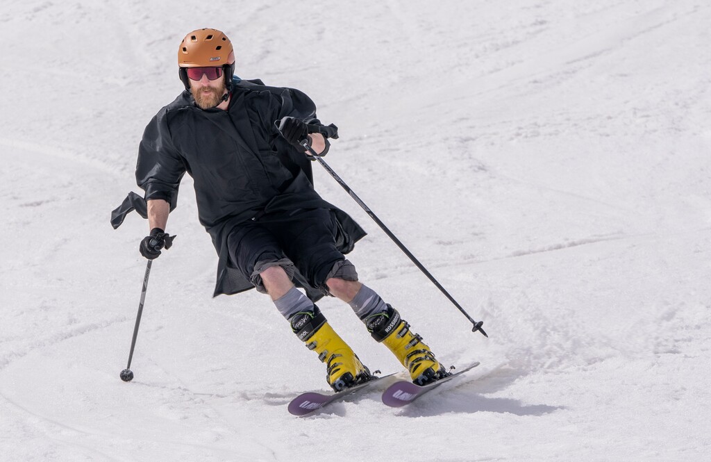 (Rick Egan | The Salt Lake Tribune)  Joseph Frank wears his graduation gown spring skiing at Solitude, on Wednesday, May 3, 2023. Frank is graduating from the University of Utah MBA program tomorrow. 