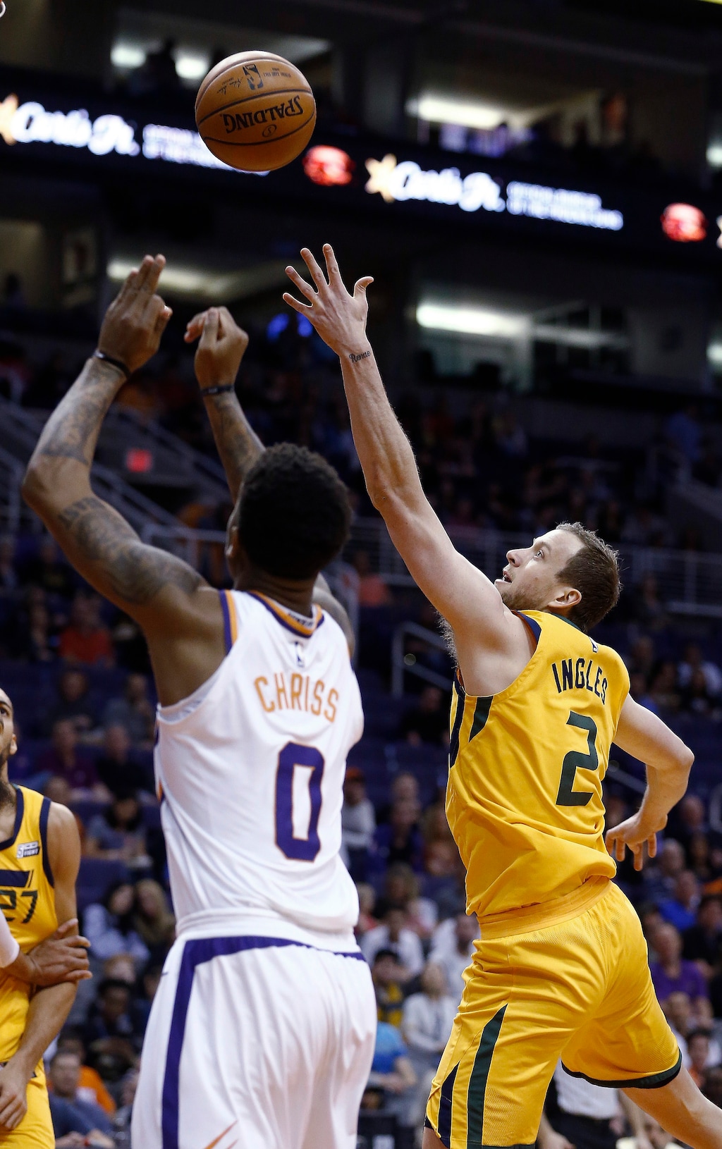 Utah Jazz forward Joe Ingles (2) gets off a shot over Phoenix Suns forward Marquese Chriss (0) during the first half of an NBA basketball game, Friday, Feb. 2, 2018, in Phoenix. (AP Photo/Ross D. Franklin)