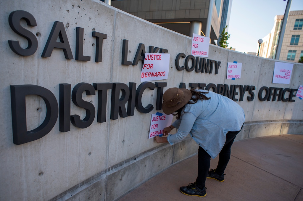(Rick Egan  |  The Salt Lake Tribune)     Demonstrators put "Justice for Bernardo"  signs on the Salt Lake County District Attorney's office sign during a Rally for Bernardo Palacios, on Wednesday, June 17, 2020.