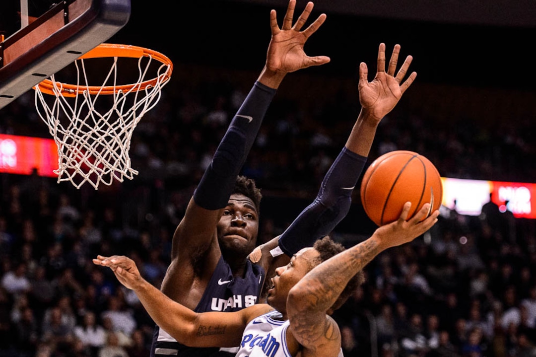 (Trent Nelson | The Salt Lake Tribune)  Brigham Young Cougars guard Jahshire Hardnett (0) shoots with Utah State Aggies center Neemias Queta (23) defending as BYU hosts Utah State, NCAA basketball in Provo on Wednesday Dec. 5, 2018.