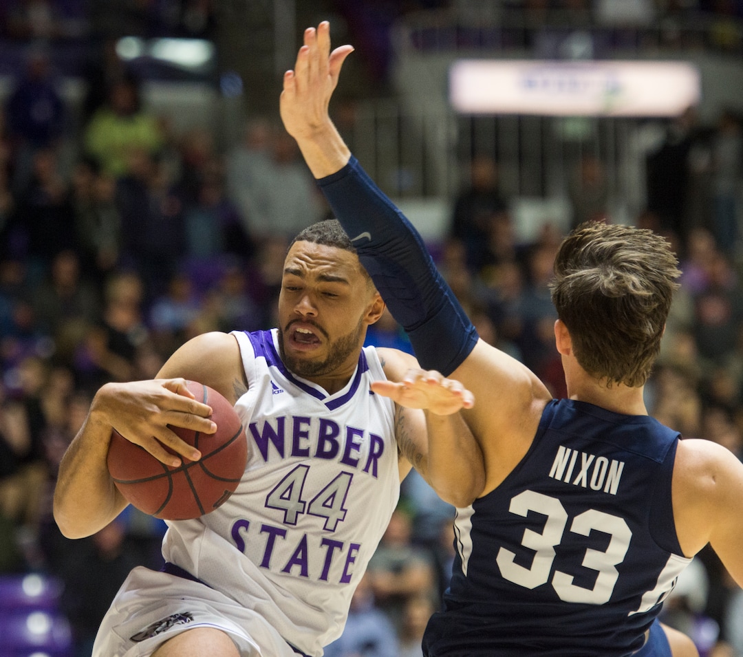(Rick Egan  |  The Salt Lake Tribune)       Weber State Wildcats center Zach Braxton (44) takes the ball inside, as Brigham Young Cougars forward Dalton Nixon (33) defends, in basketball action  between Brigham Young Cougars and Weber State Wildcats, at the Dee Event Center in Ogden, Saturday, Dec. 1, 2018.