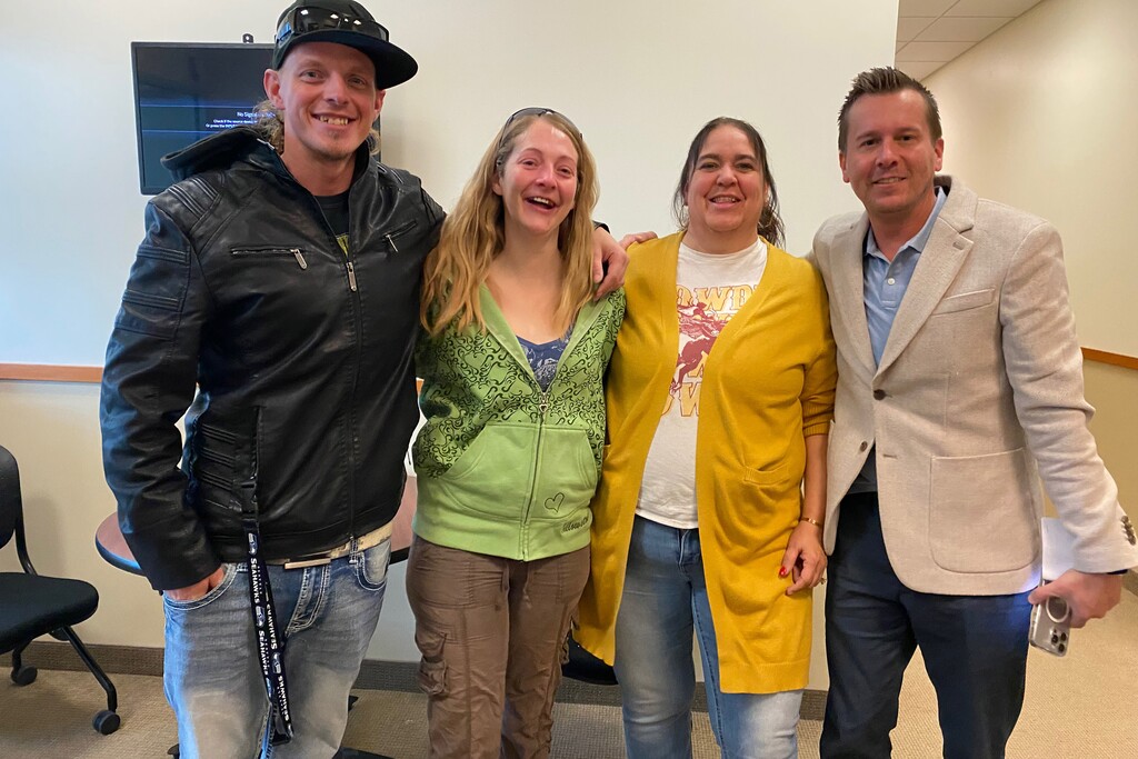 (Lillian Mongeau Hughes for KFF Health News) Garrett Clark (left) puts his arm around his sister, Shantel, minutes after she was released from the Sanpete County Jail in rural Utah in December. Cheryl Swapp (second from right) helps smooth detainees’ transition to the outside as the jail’s community health worker. Ryan Montag (right) has been helped by Swapp in the past.