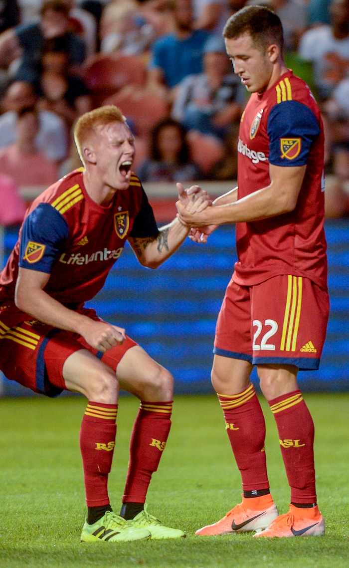 (Leah Hogsten  |  The Salt Lake Tribune) Real Salt Lake defender Justin Glad is helped to his feet by Real Salt Lake defender Aaron Herrera (22) after Glad was hit in the mouth. Real Salt Lake hosts the Seattle Sounders, Aug. 14, 2019, at Rio Tinto Stadium in Sandy. RSL defeated the Sounders 3-0.