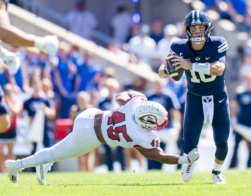 (Rick Egan | The Salt Lake Tribune) Brigham Young Cougars quarterback Kedon Slovis (10) tries to shake Southern Utah Thunderbirds linebacker Josh Lopez (45) at LaVell Edwards Stadium on Sept. 9, 2023.